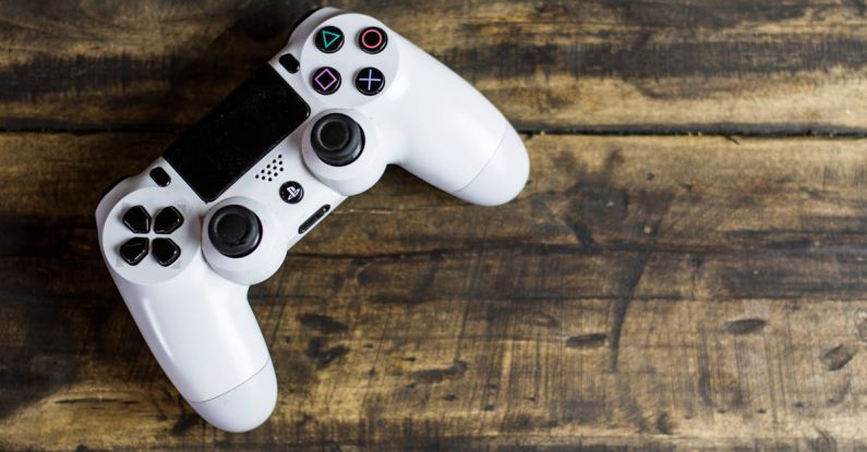 Games - White Gaming Console on Wooden Surface