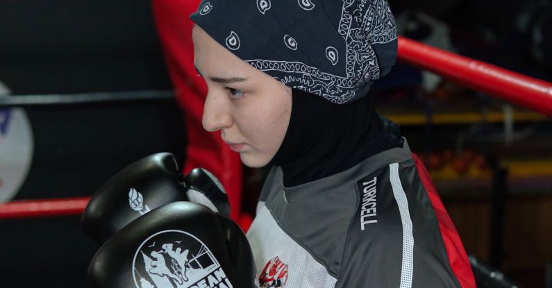 High-Altitude Training - A young woman wearing a headscarf and boxing gloves