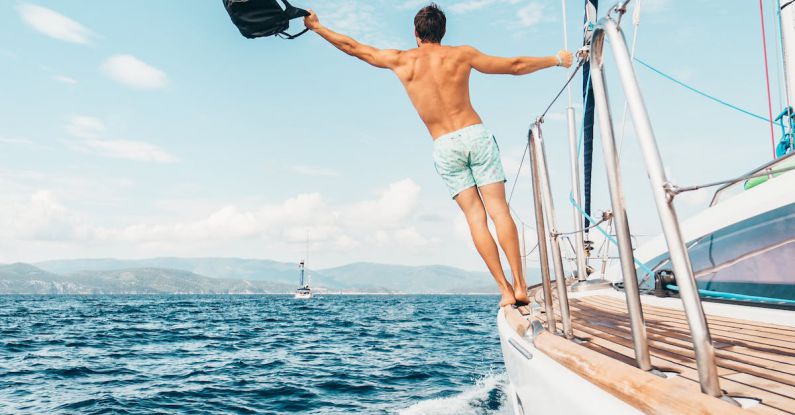 Yacht Charters - Man Holding Black Backpack