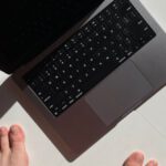 First-Class - Macbook Pro 14 keyboard at an angle in sunlight