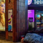 Boutique Hotels - Person Sleeping In Pavement Near Glass Window