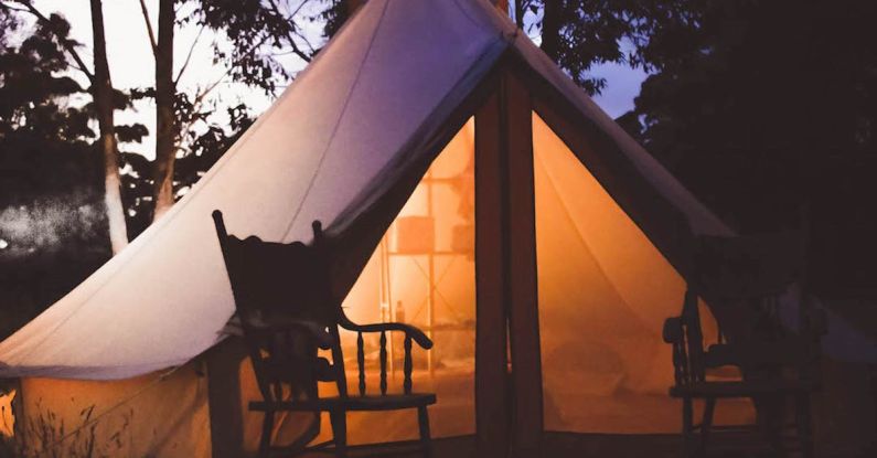 Glamping - White and Brown Lighted Cabin Tent at Woods