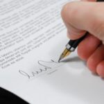Document - Person Signing in Documentation Paper
