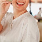 Local Economies - Happy ethnic woman with salad leaf