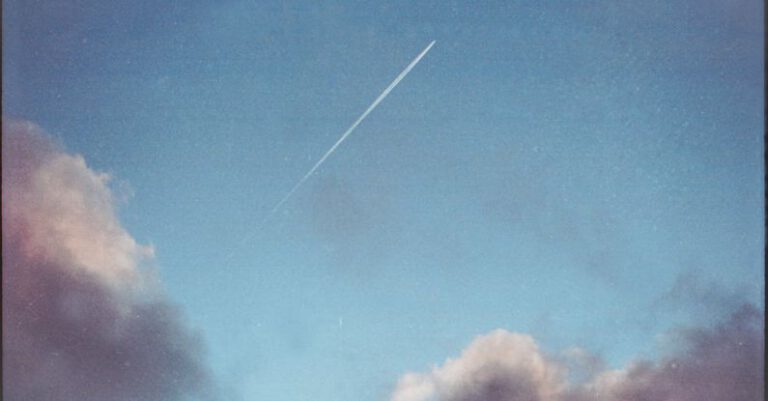 Leave No Trace - Photo of the Sky with Clouds and a Trace Leaving by an Airplane