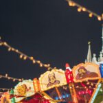 Festival Tourism - Colorful luminous carousel against Kremlin on Red Square at night