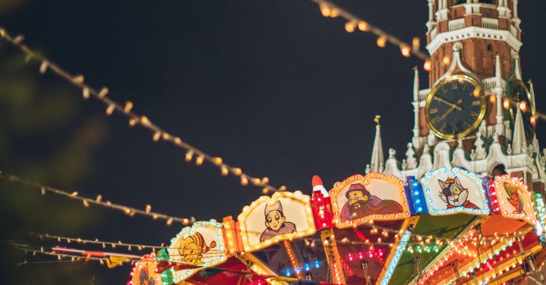 Festival Tourism - Colorful luminous carousel against Kremlin on Red Square at night