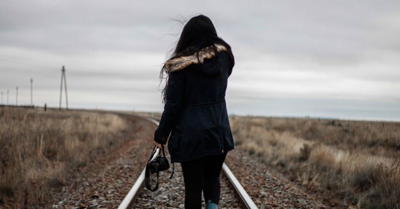 Solo Road Trips - Woman Walking in Middle of Railway