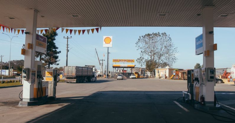 Fuel Costs - Empty gas station with oil petrol dispensers located on highway for serving long distance vehicles