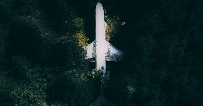 Break Down - Drone view of modern white broken abandoned plane crashed in green dense forest